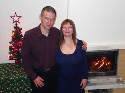 muž a žena u vánočního stromku u krbu